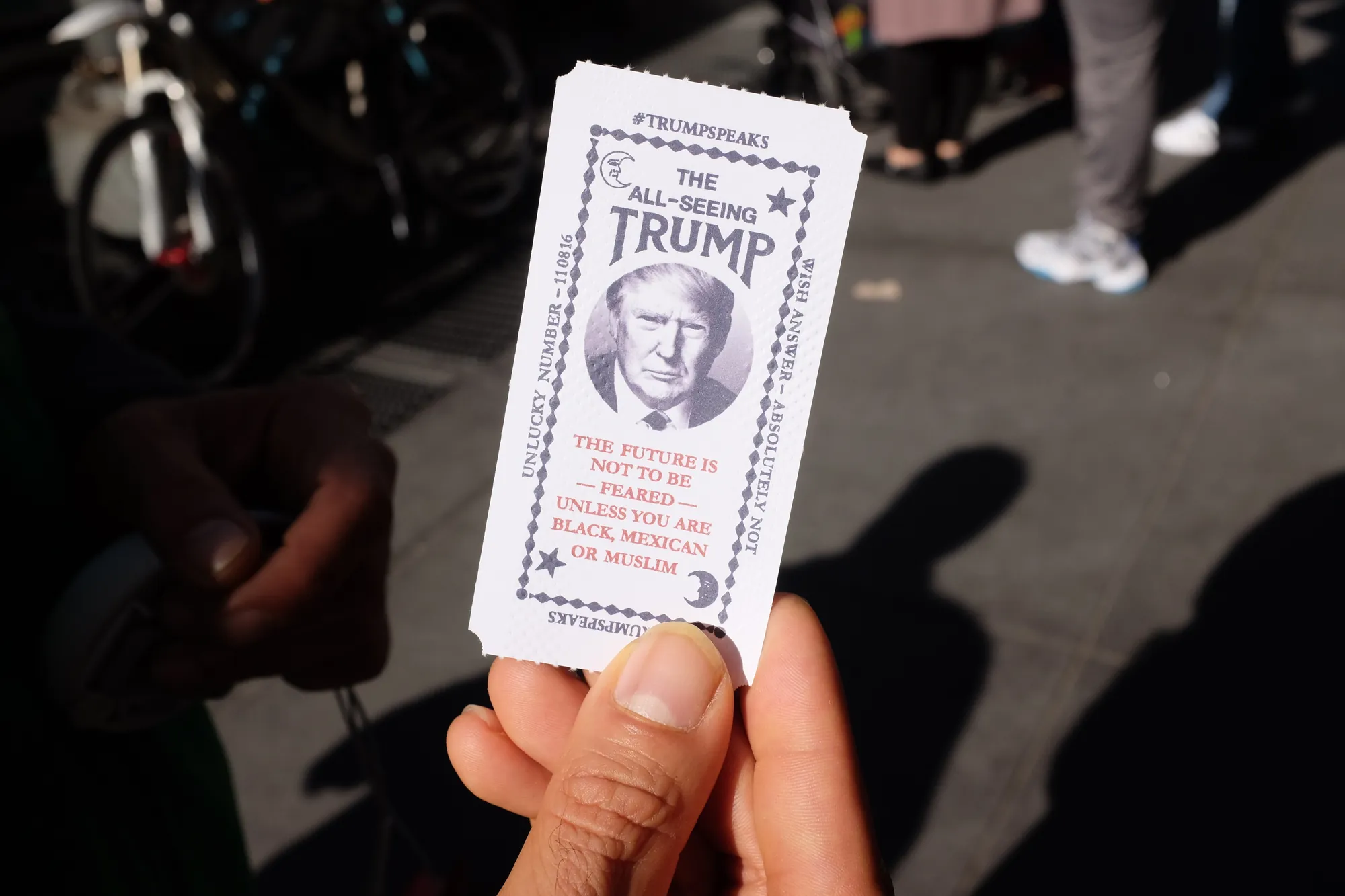 A fortune ticket from the machine held up on the street